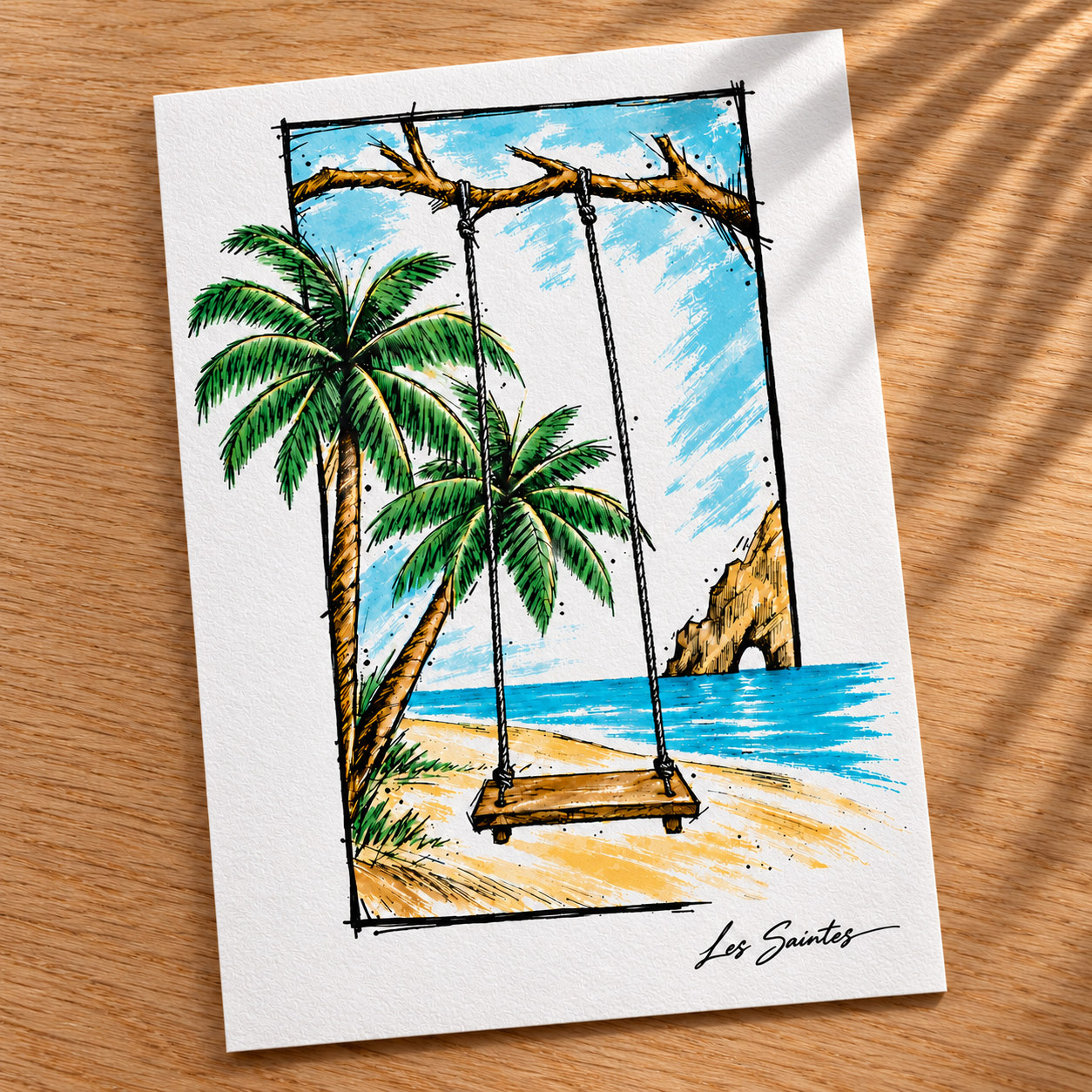 Carte postale — Balançoire tropicale, papier texturé posé sur une table avec une légère ombre de feuillage — Atelier Karaïbes, Les Saintes