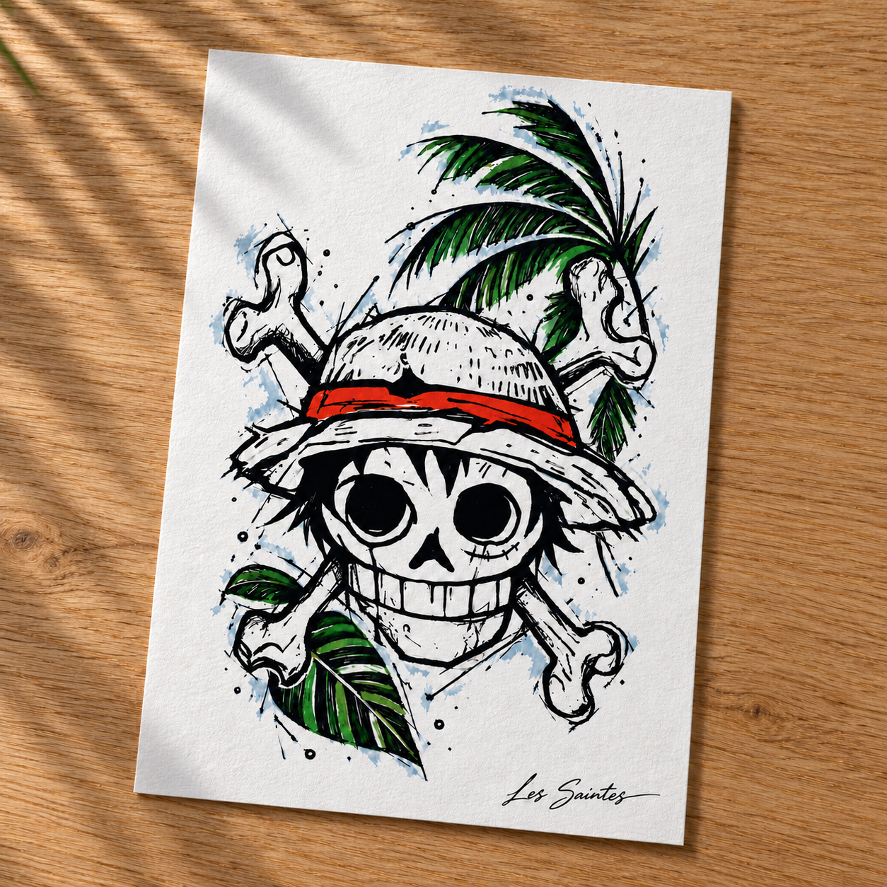 Carte postale — Pirate tropical, papier texturé posé sur une table avec une légère ombre de feuillage — Atelier Karaïbes, Les Saintes